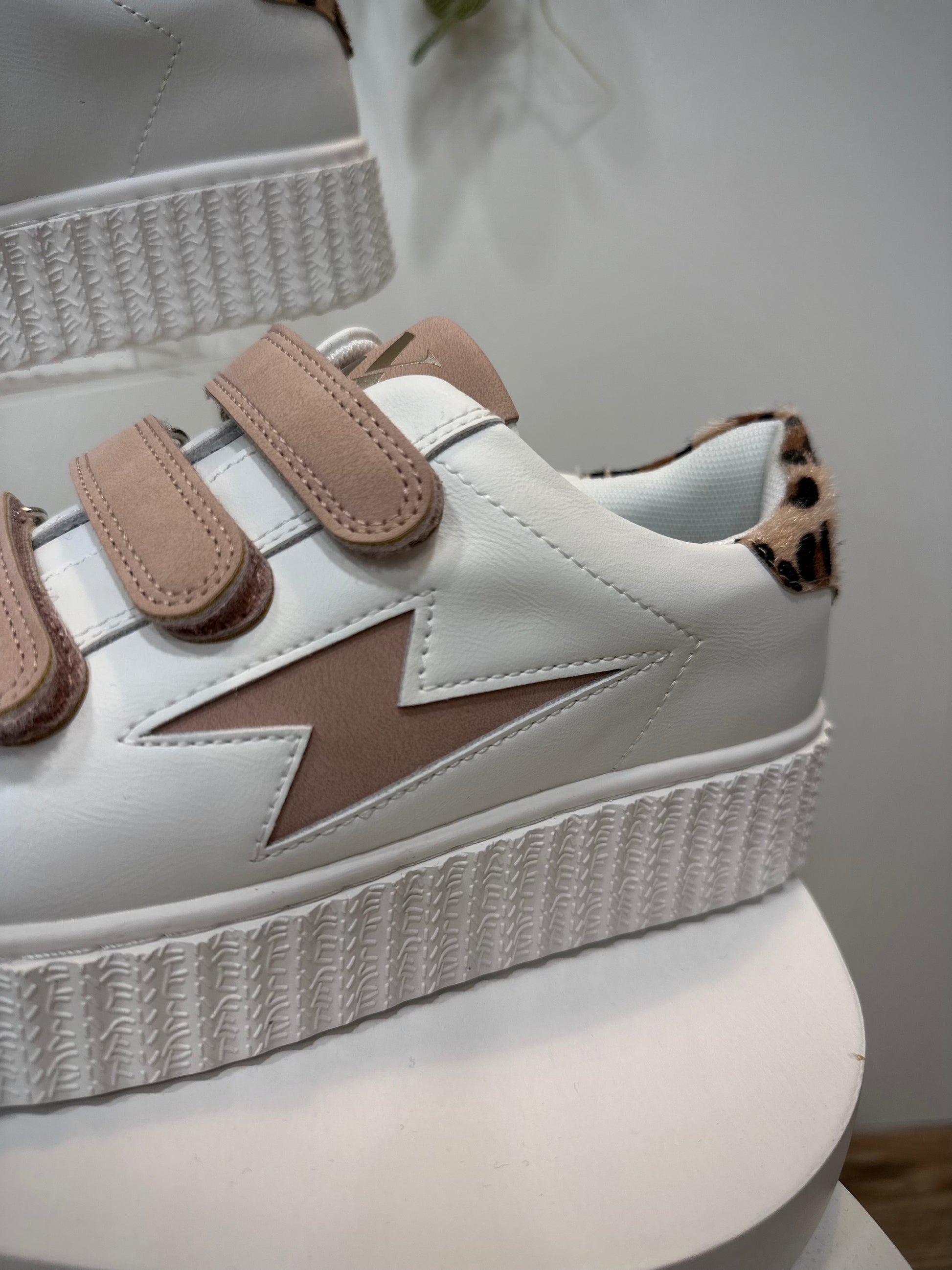 Gros plan sur la découpe éclair rose poudré des sneakers