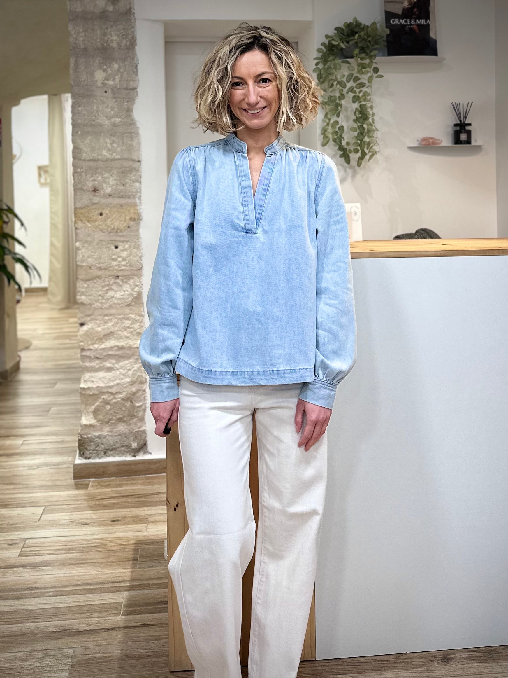 Femme portant une blouse en denim bleu ciel coupe droite