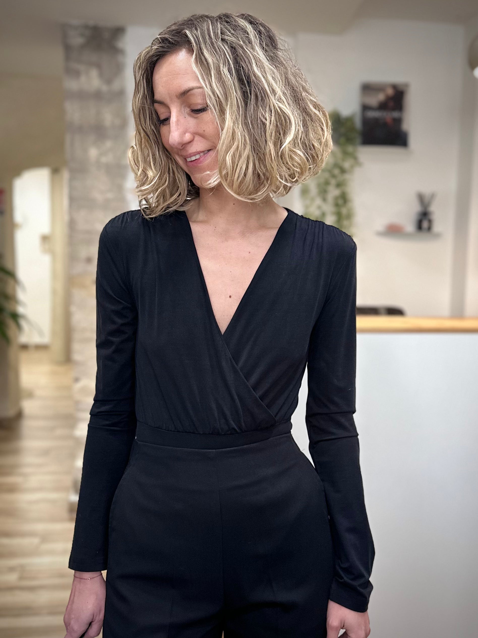 Femme portant un body noir cache-cœur élégant