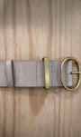 Détail boucle dorée brillante sur ceinture femme beige suédine
