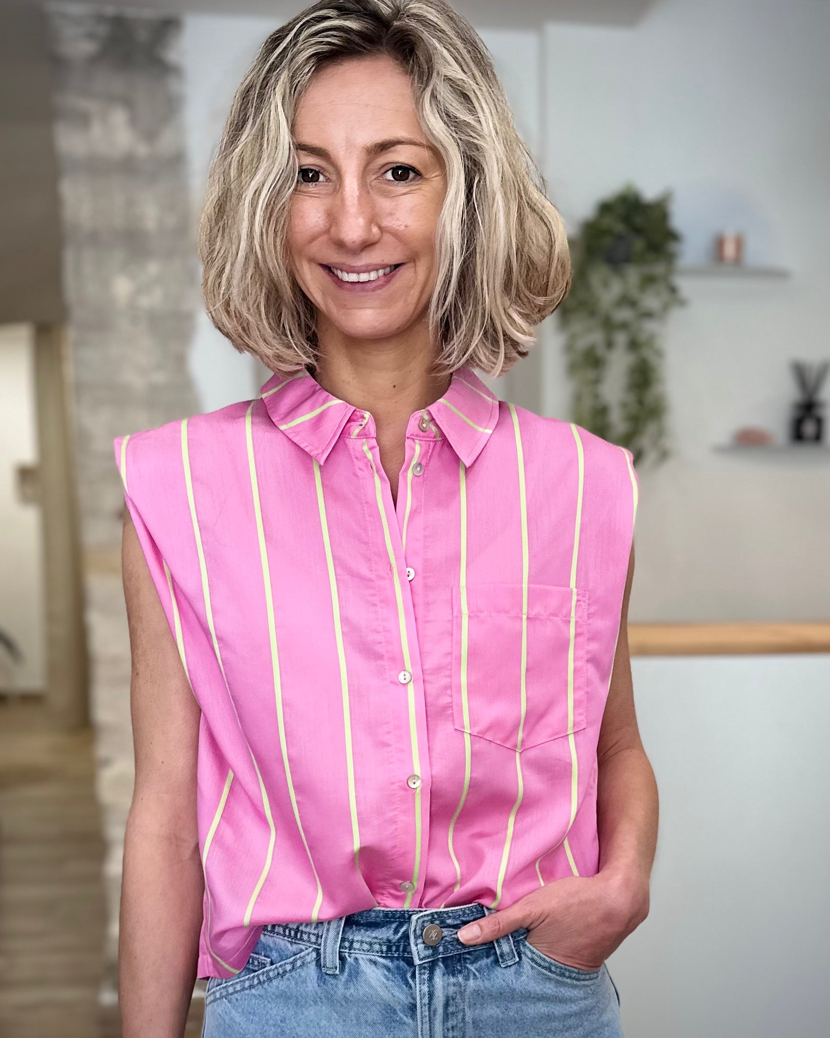 Femme portant une chemise rose à rayures vert fluo fluide 