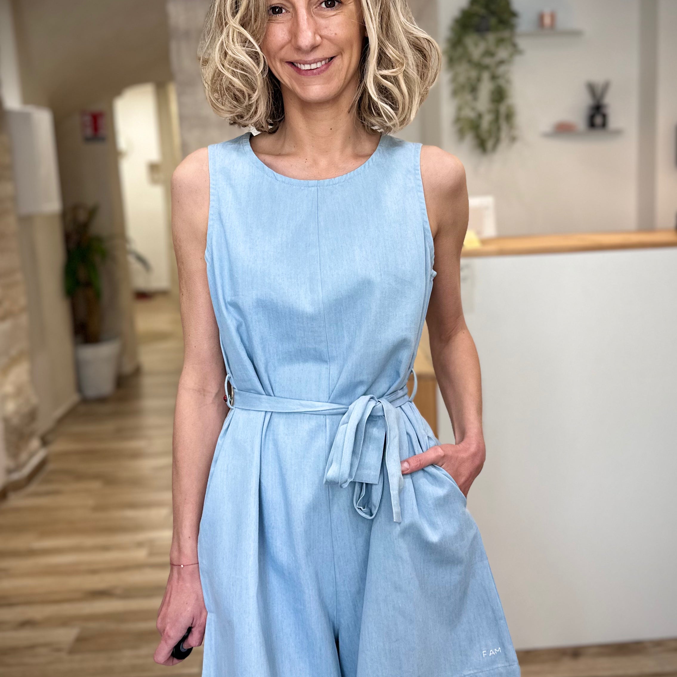 Femme portant combinaison short bleu clair en coton coupe fluide 