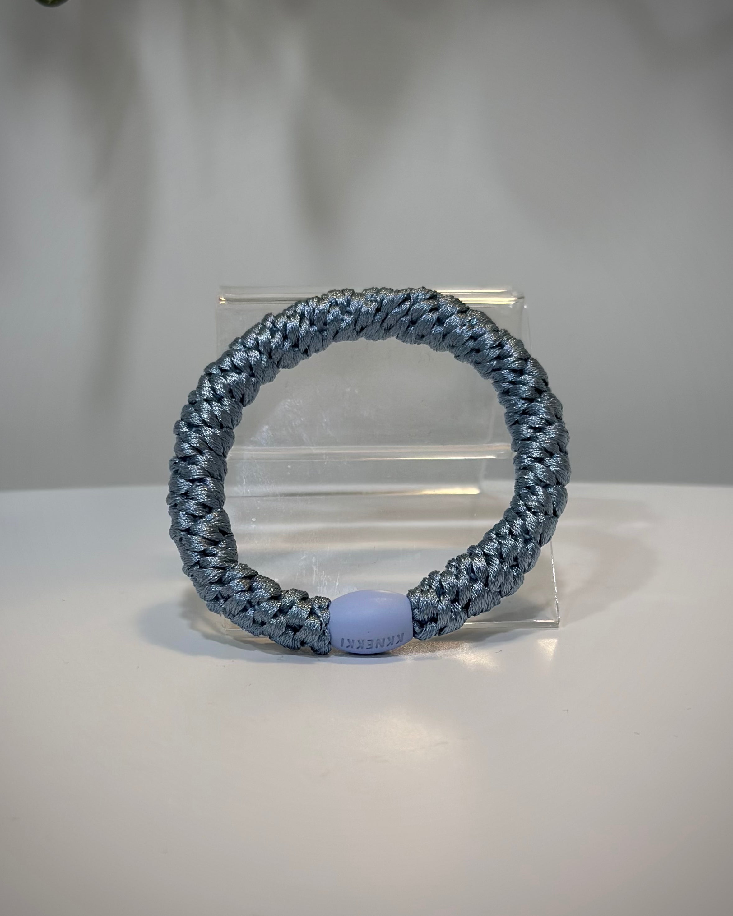 élastiques Kknekki bleu ciel posés sur une table en bois clair