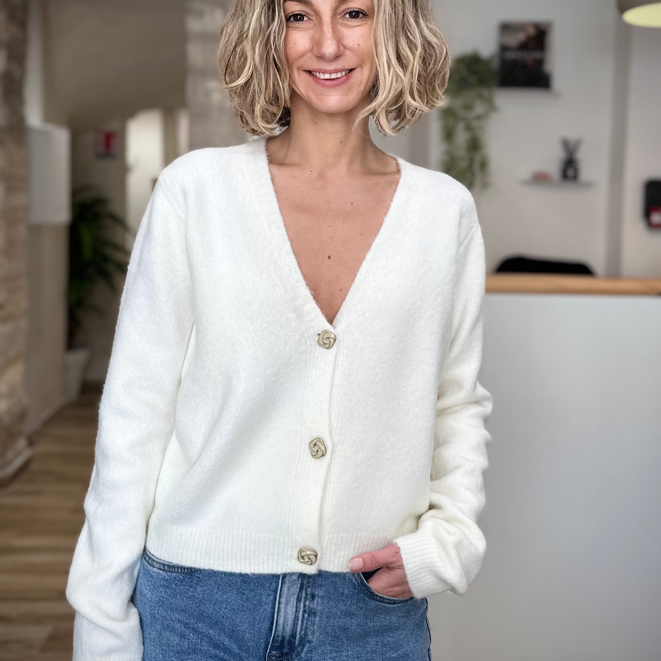 Femme portant un gilet blanc boutonné devant
