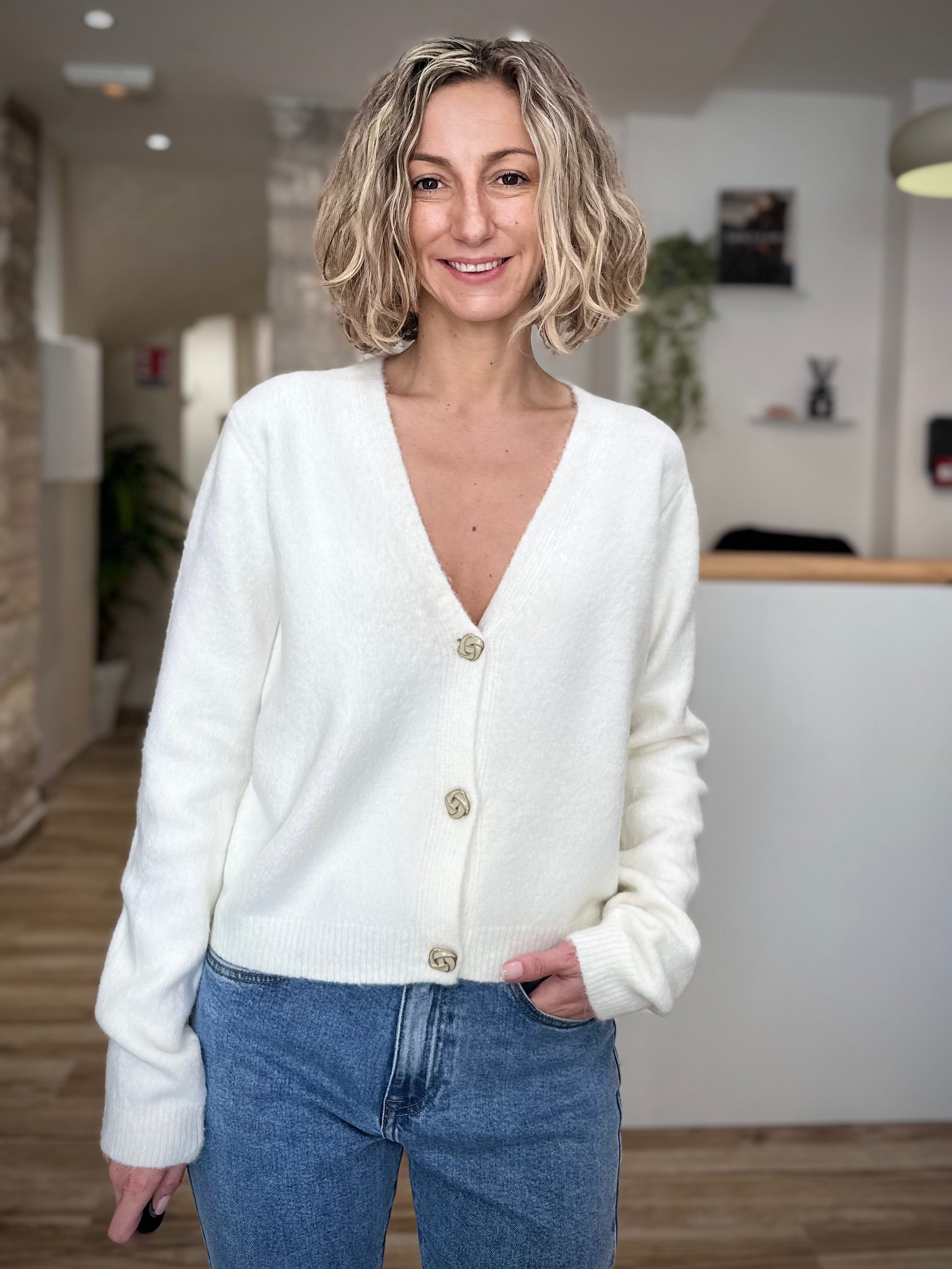 Femme portant un gilet blanc boutonné devant