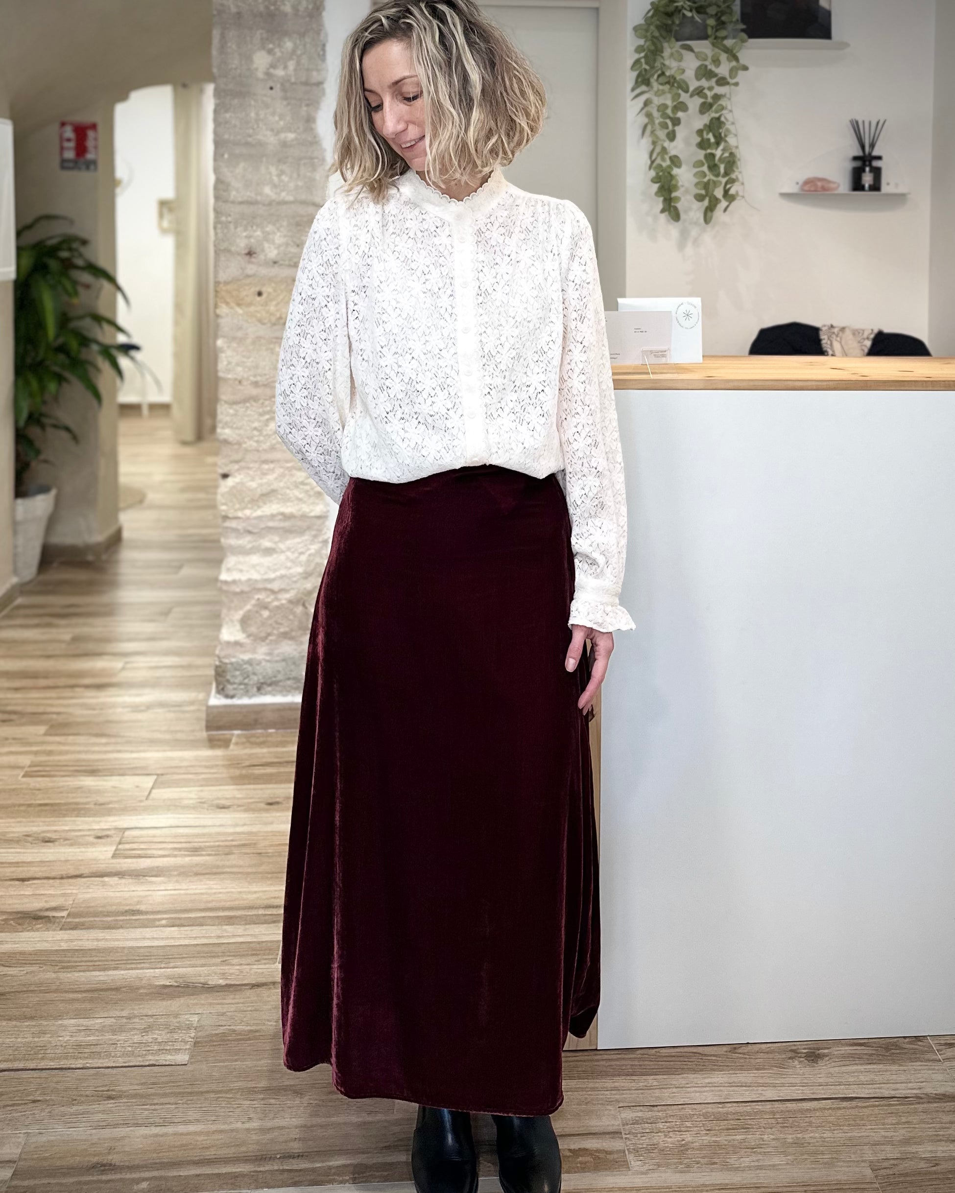 Femme portant une jupe midi en velours bordeaux casual chic