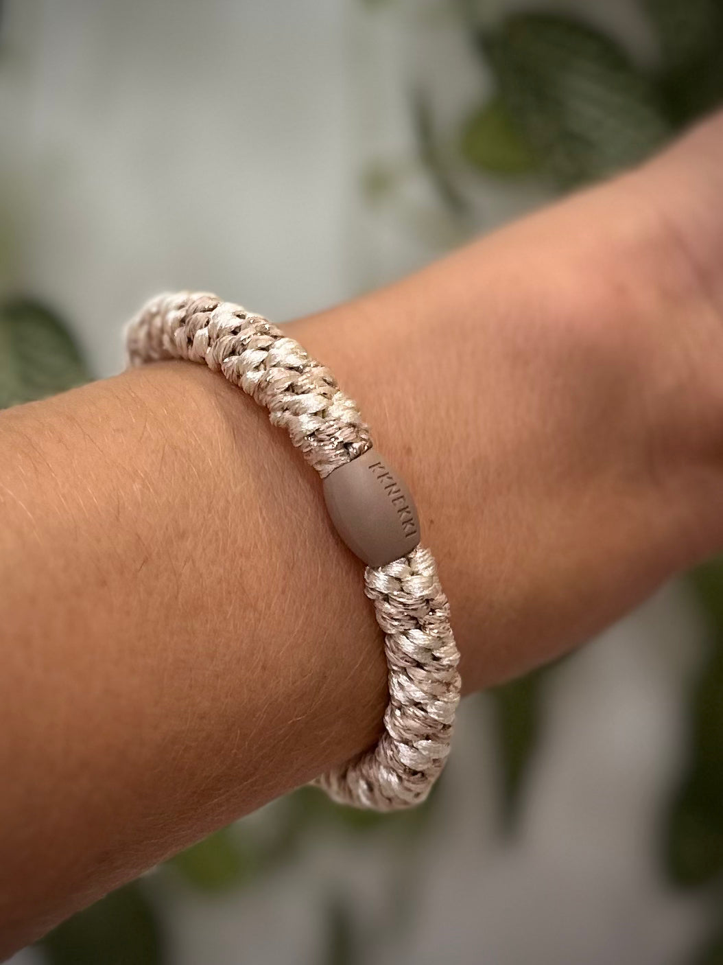 Elastique Kknekki pailleté ivoire beige porté comme bracelet sur poignet femme