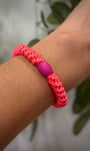 Elastique Kknekki rose néon porté comme bracelet sur poignet femme
