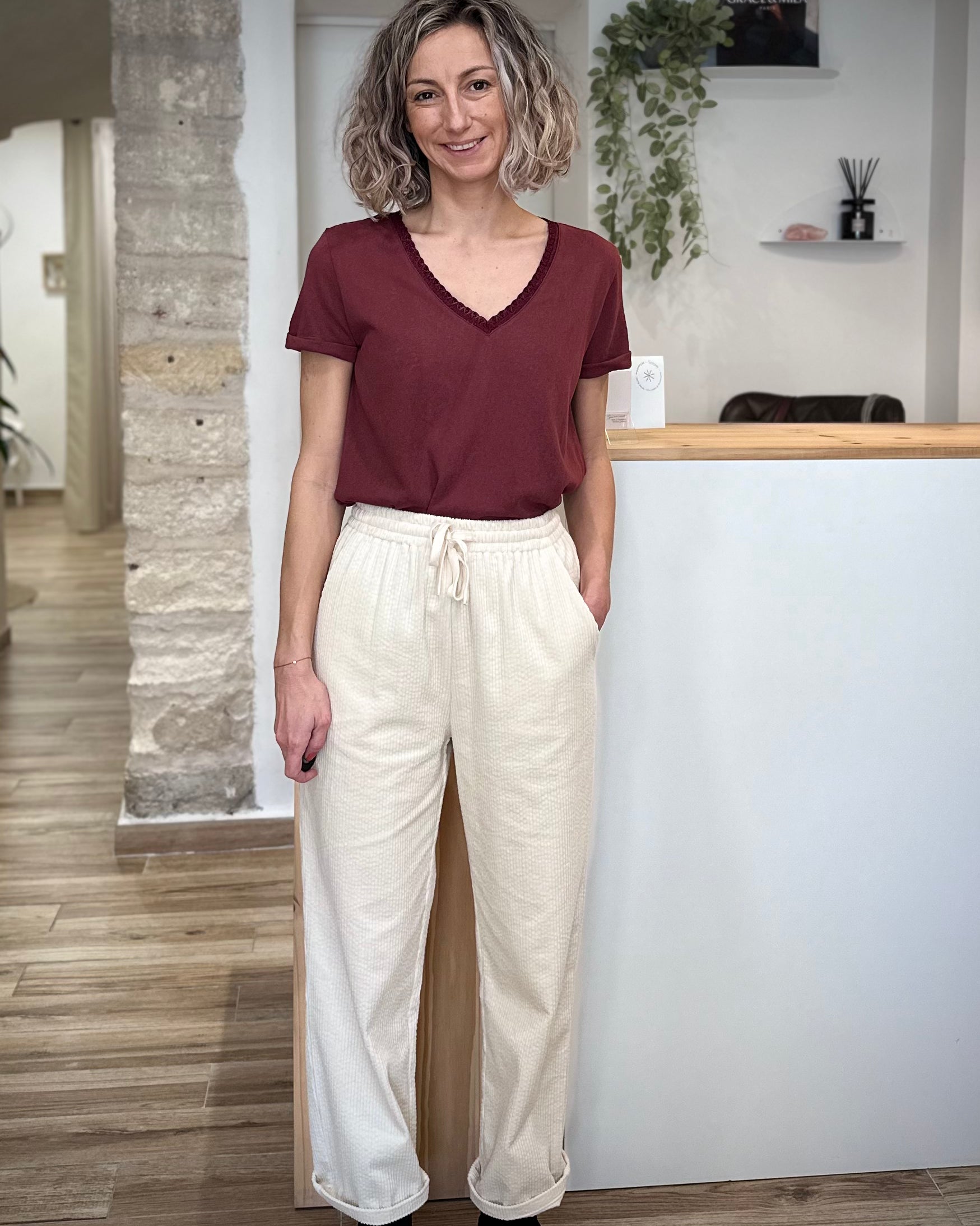 Femme portant un pantalon large en velours écru