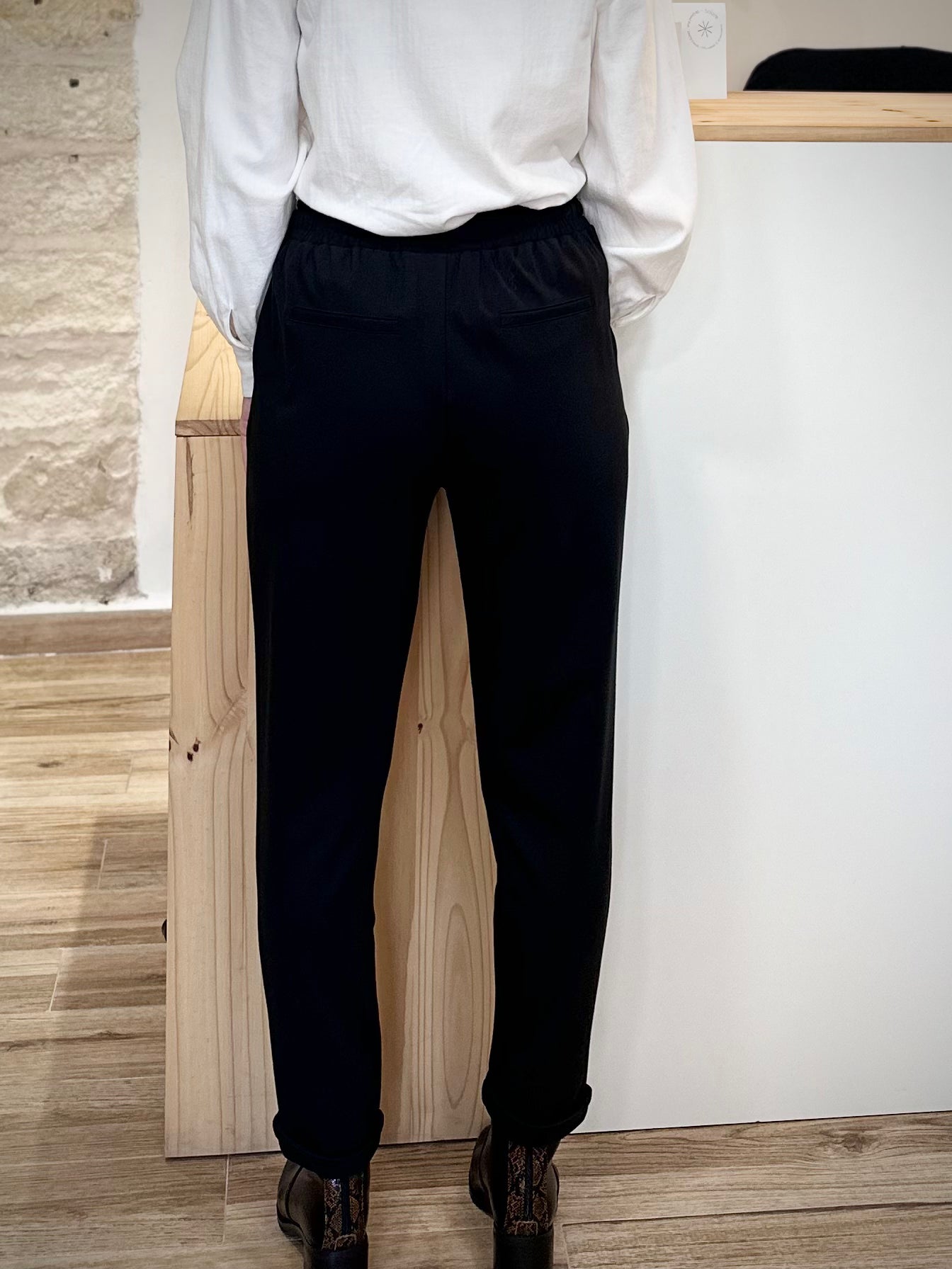 Détail de la taille élastiquée au dos d’un pantalon noir