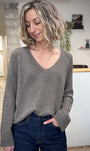 Femme portant un pull en lurex taupe à col V