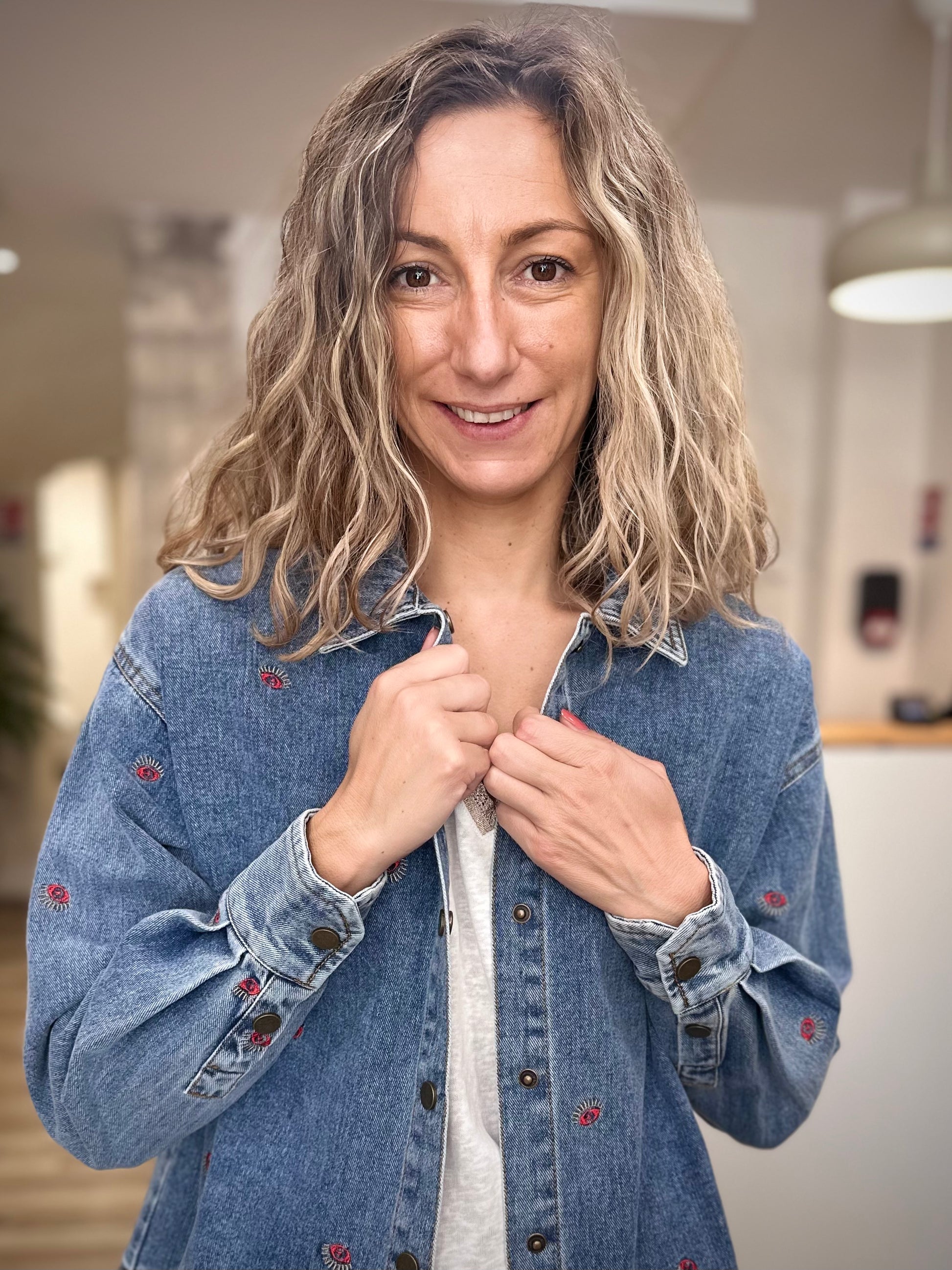 Zoom sur la forme liquette d’une veste en jean brodée